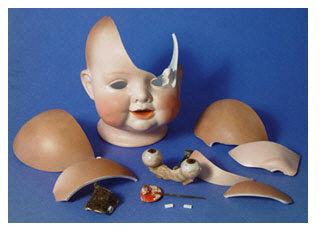 pieces of a broken porcelain doll's head