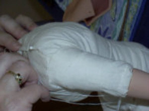doll body being sewn together